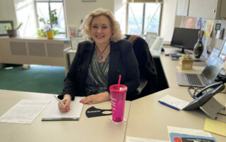 Senator Carol Blood sits at her desk.