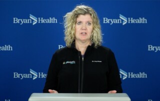 Dr. Amy Pinkall stands behind the podium at the Bryan Health Medical Center's conference on upper respiratory infections.