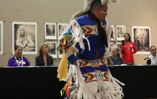 A dancer in traditional garb is photographed while dancing.